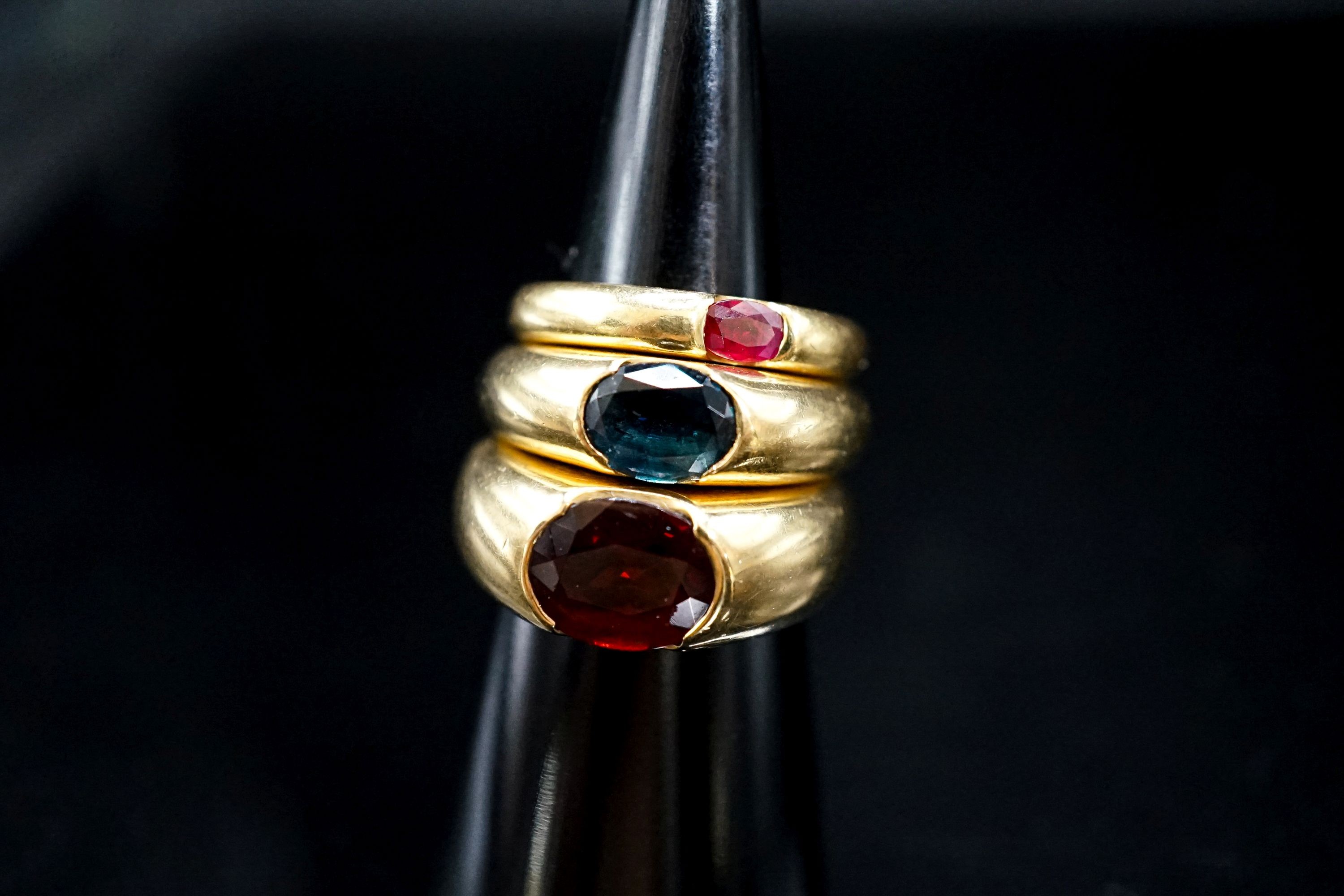 Two 18ct and gypsy set gem set rings, maker TR, size M and a similar smaller ring, size H, gross weight 20 grams.